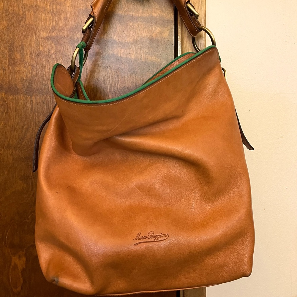 Marco Buggiani (Dooney and Bourke) 13L x 14W x 12” opening. Strap has a 8” drop.
